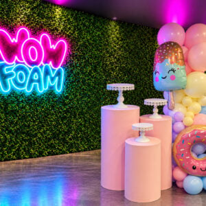 Custom balloon wall garland matching your theme or colors, with cake stands included from Wow Foam